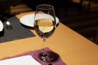 テーブルに置かれた一杯の白ワイン